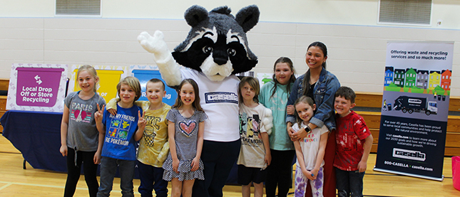 A group of children with the Casella mascot, at a community recycling event.