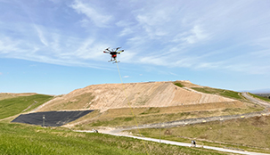 A drone flying over a landfill