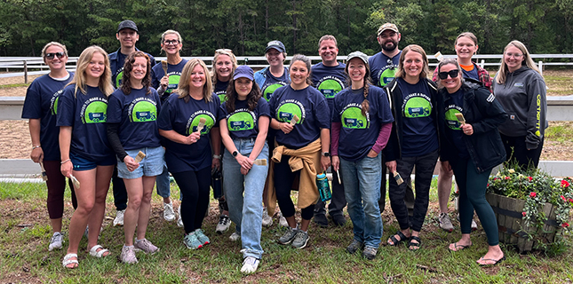 A group of Casella employees at a volunteering event wearing matching shirts